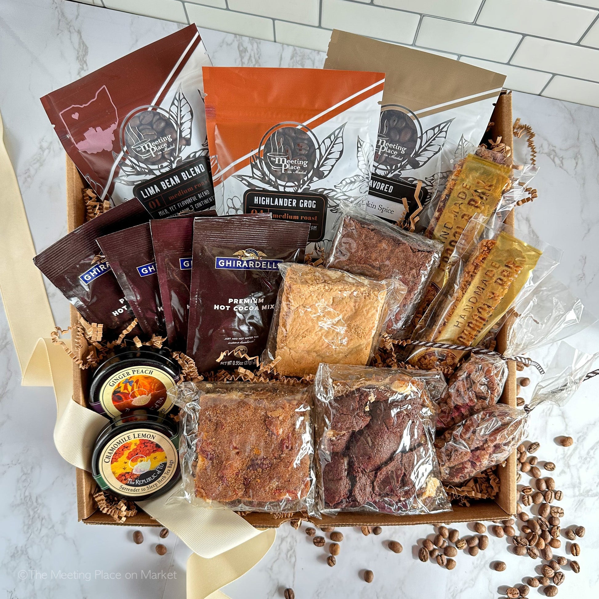 https://meetingplaceonmarket.com/cdn/shop/products/thanksgiving-family-friends-gift-basket-with-coffee-tea-cocoa-brownies-granola-529589.jpg?v=1690483781&width=1946